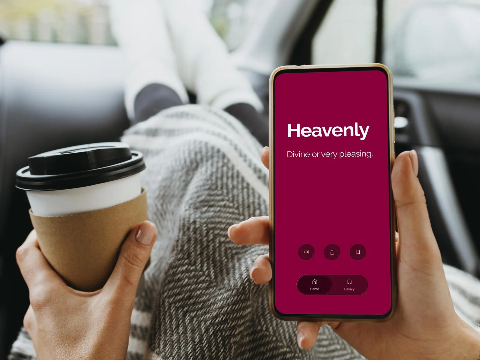 A hand holding a phone with the Lovely Words card “Heavenly: Divine or very pleasing.”, a coffee cup in the other hand